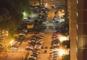 Top view of the Parking of cars near high-rise buildings.