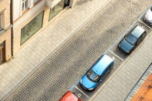 Cars parked along city curb.