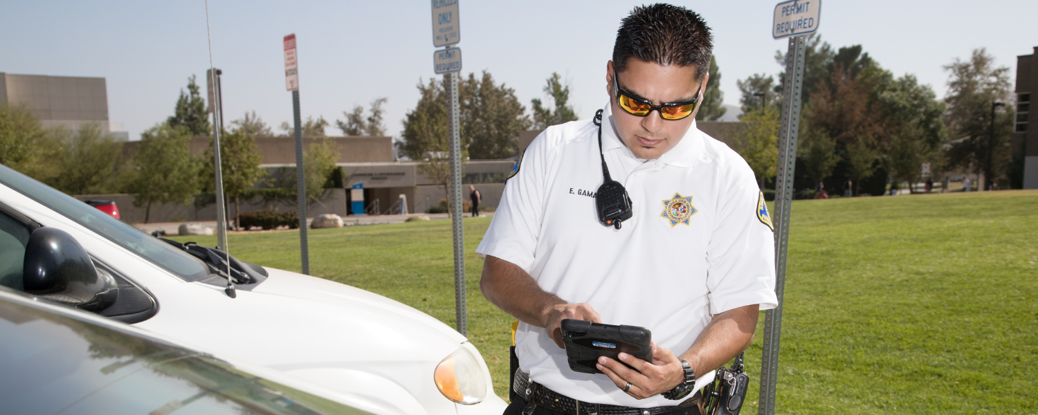 Parking Enforcement Officer checking credentials for a parked car