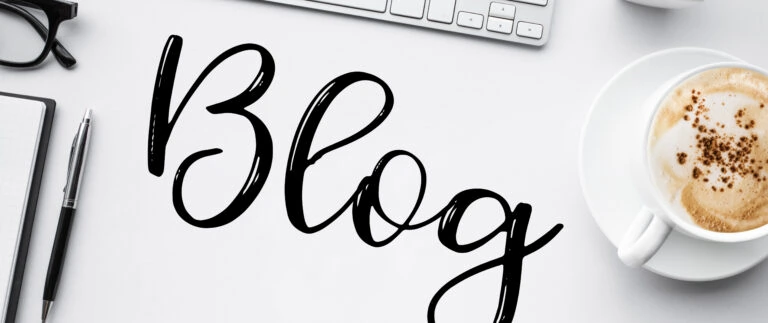 Blogging graphic showing blog concepts with keyboard, pen and paper and coffee