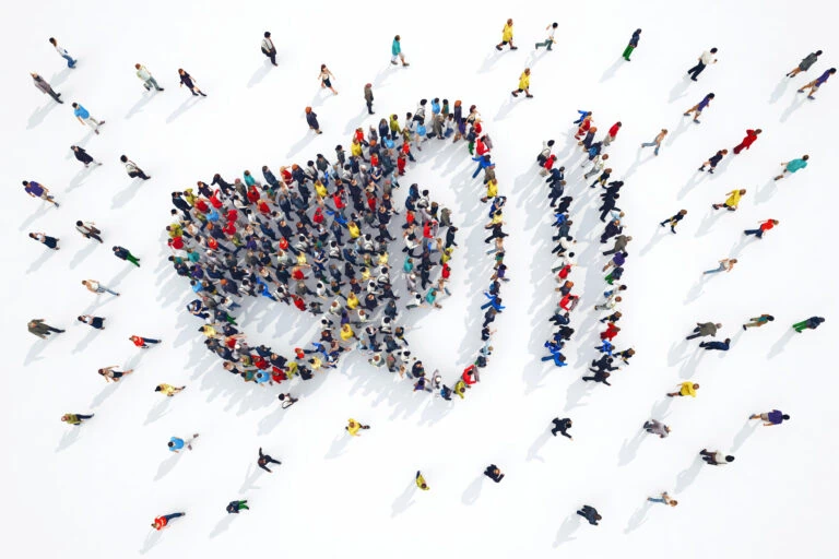 People that form the symbol of a megaphone when seen from above